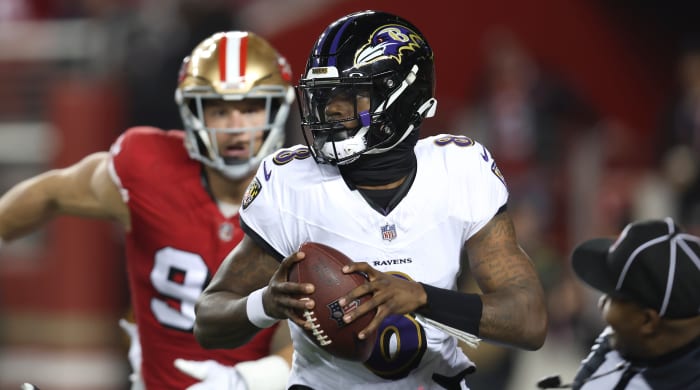 Ravens quarterback Lamar Jackson is chased by 49ers defensive end Nick Bosa